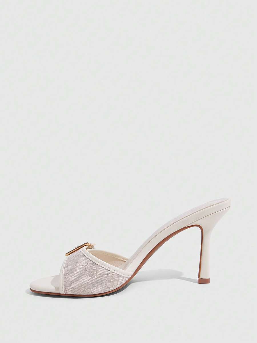 Women's brown leopard print high heel mule sandals with gold-tone buckle and grommet eyelet accents.