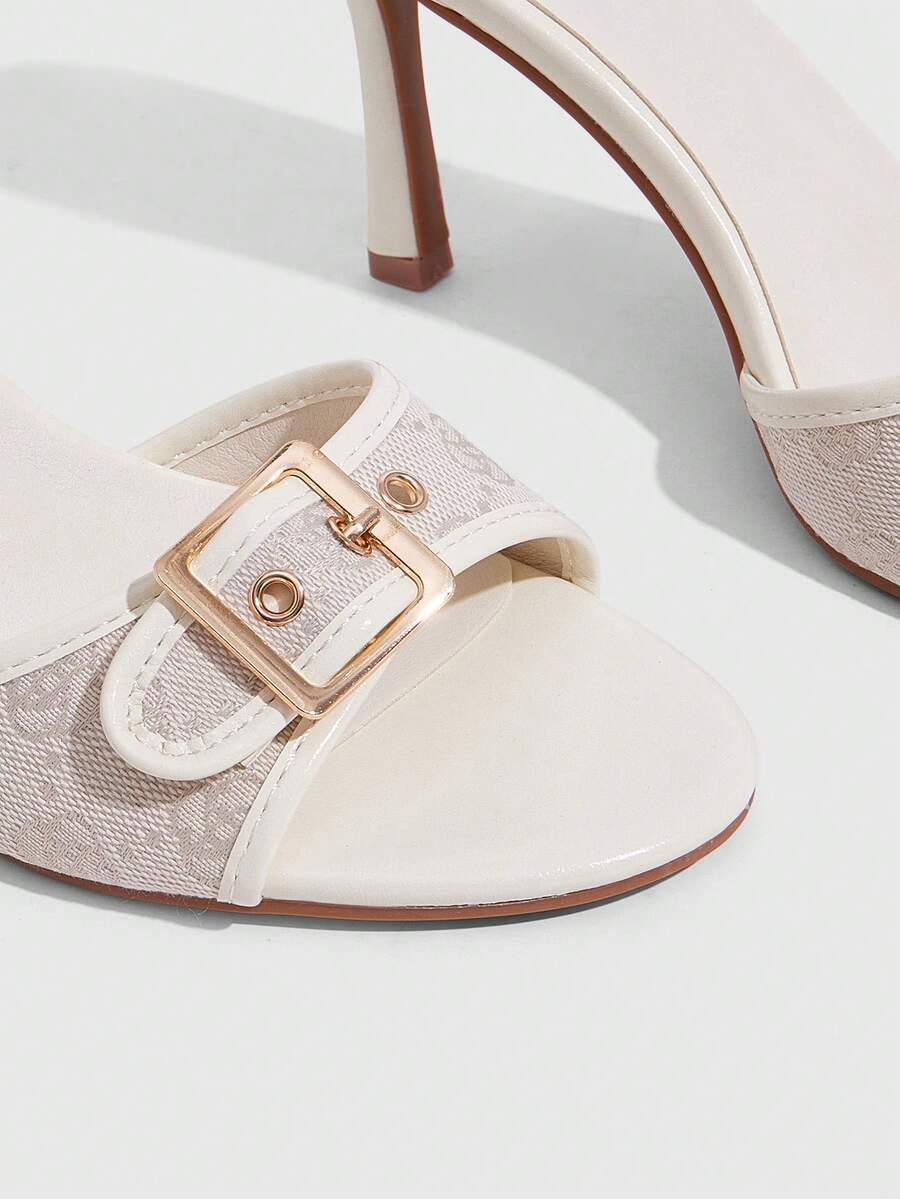 Women's brown leopard print high heel mule sandals with gold-tone buckle and grommet eyelet accents.