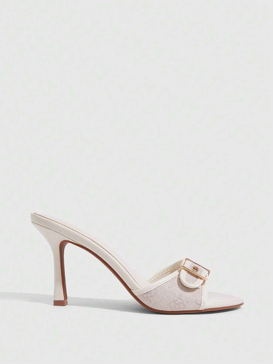 Women's brown leopard print high heel mule sandals with gold-tone buckle and grommet eyelet accents.