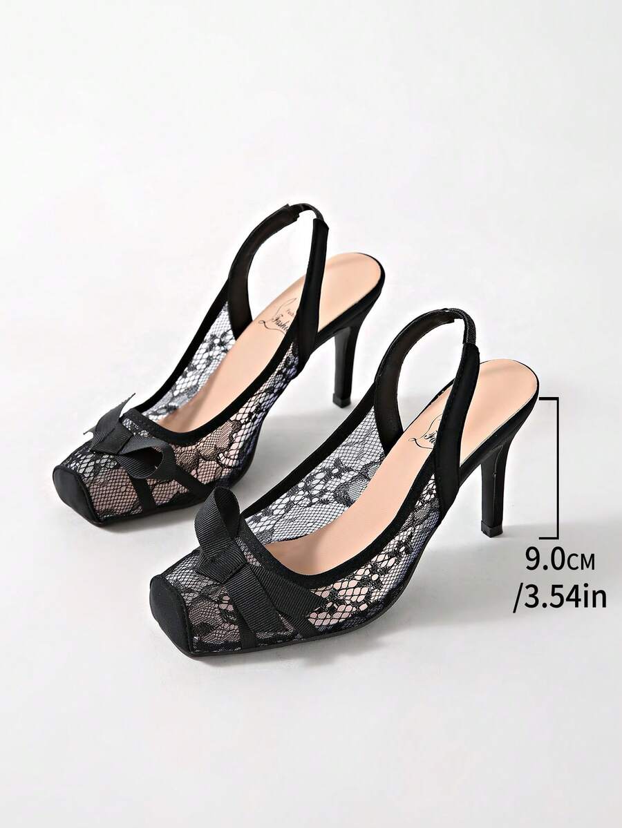 Black lace high heel sandals for women with a big bowknot, closed square toe, and stiletto heel.