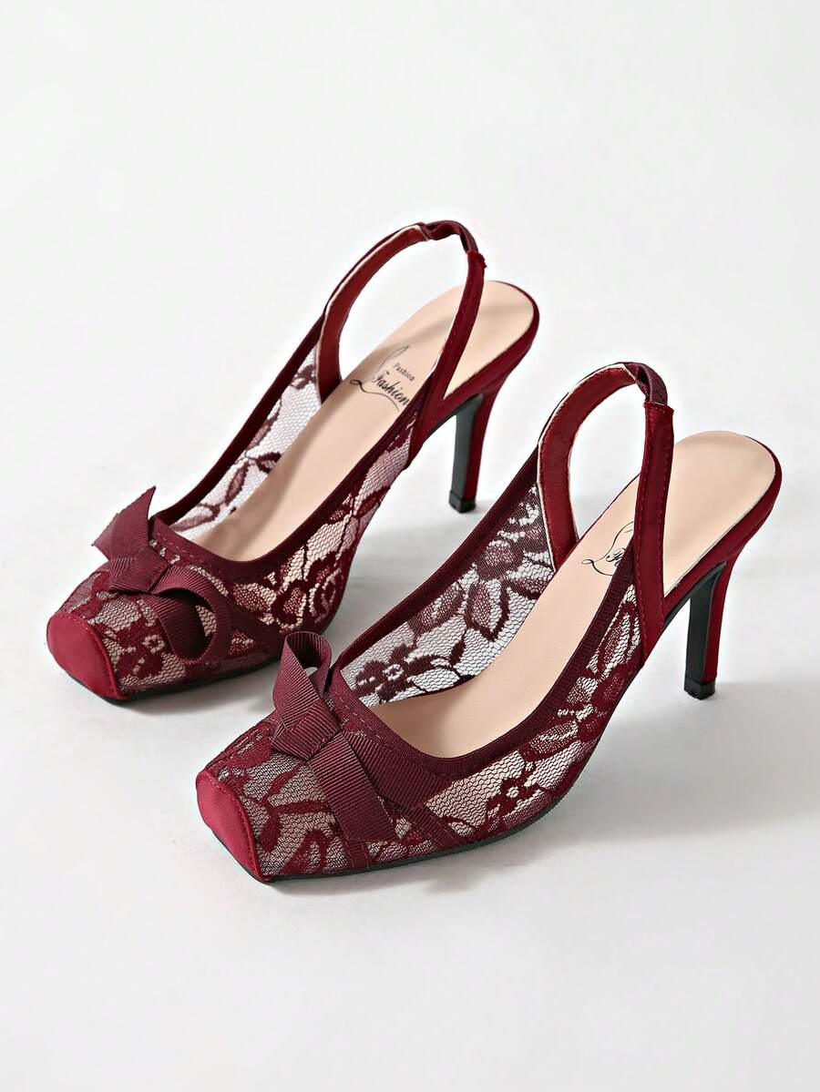 Black lace high heel sandals for women with a big bowknot, closed square toe, and stiletto heel.