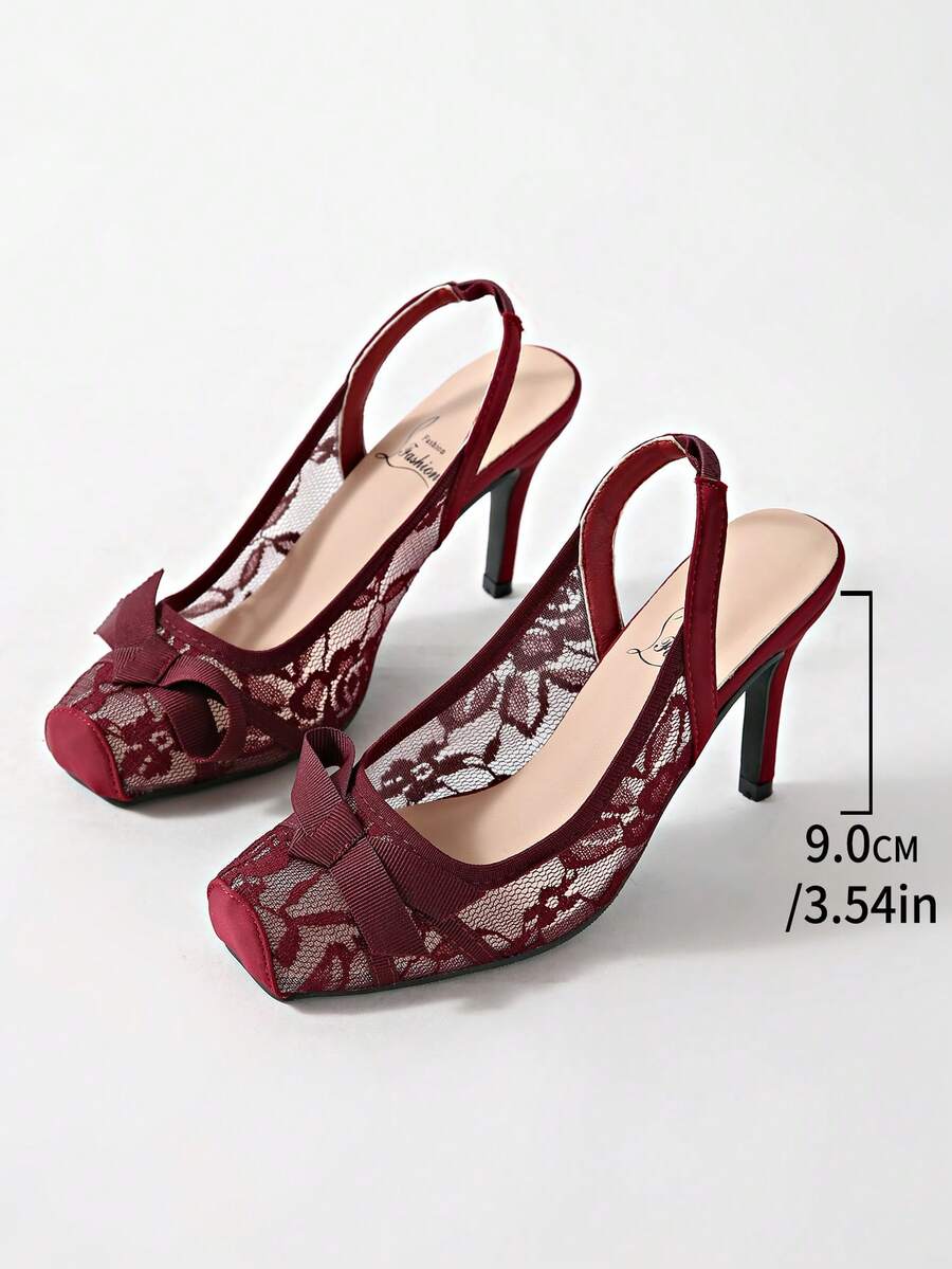 Black lace high heel sandals for women with a big bowknot, closed square toe, and stiletto heel.