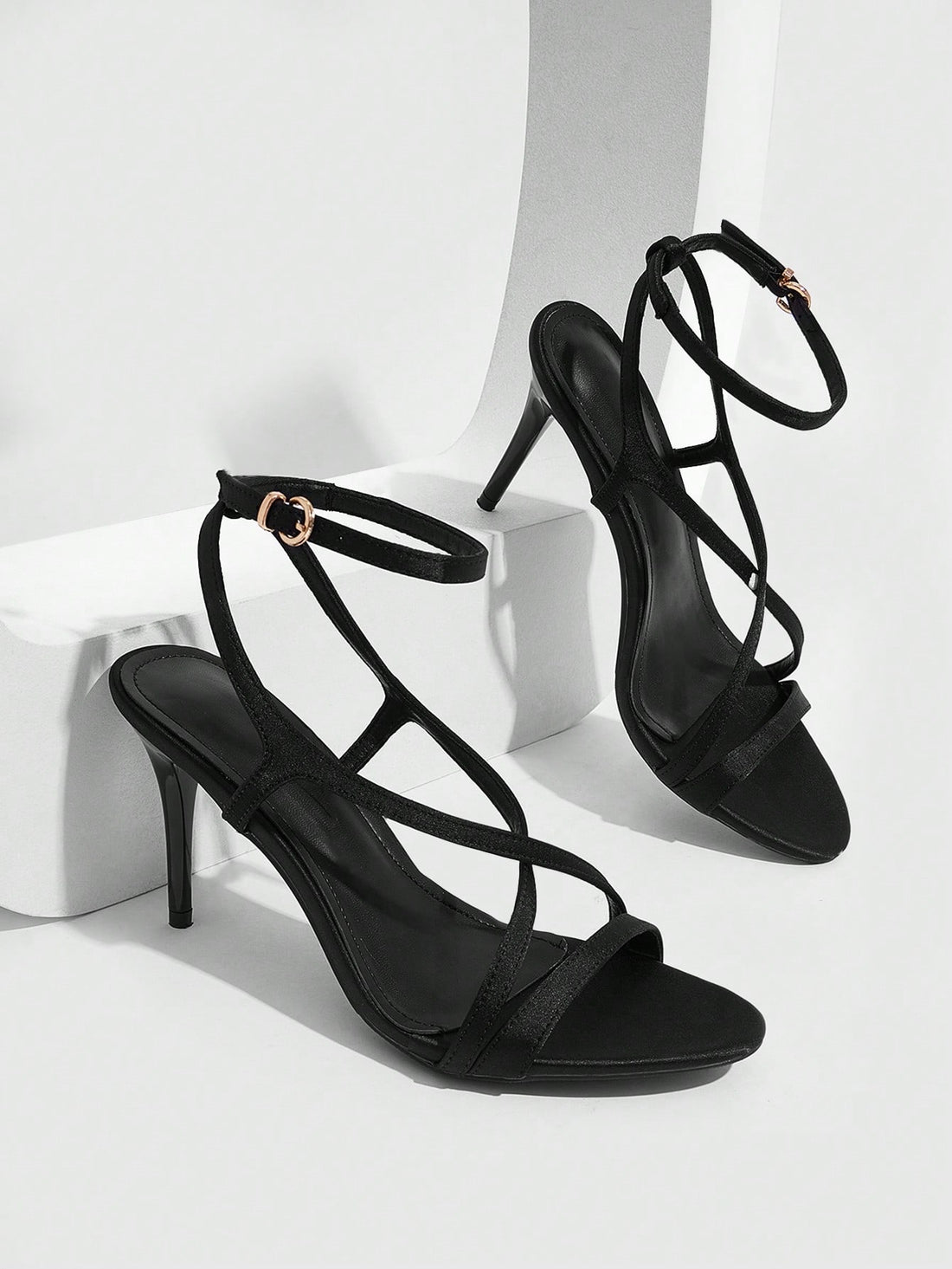 Square toe stiletto high heel sandals in deep burgundy satin featuring criss cross straps and an open toe design.