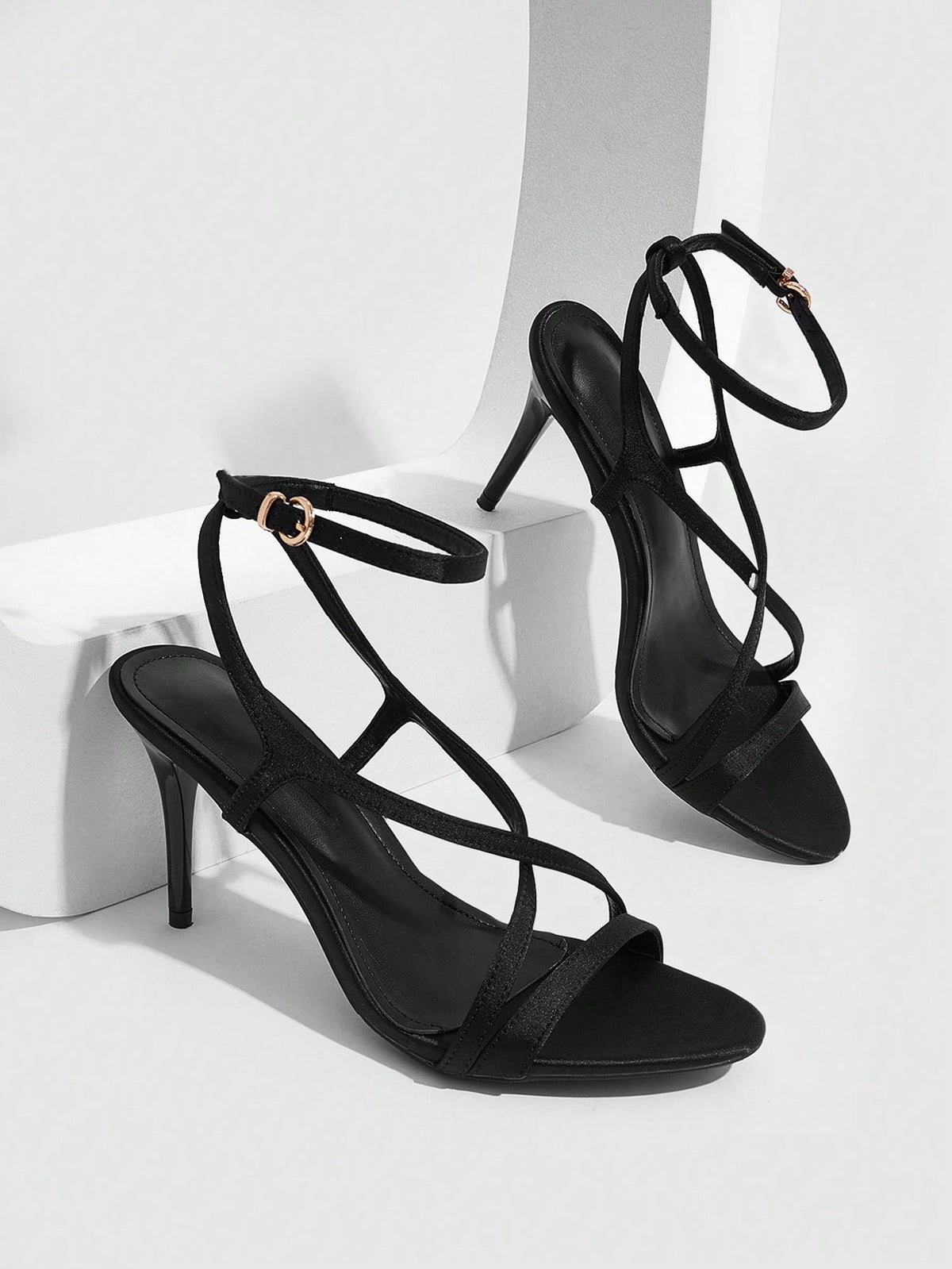 Square toe stiletto high heel sandals in deep burgundy satin featuring criss cross straps and an open toe design.