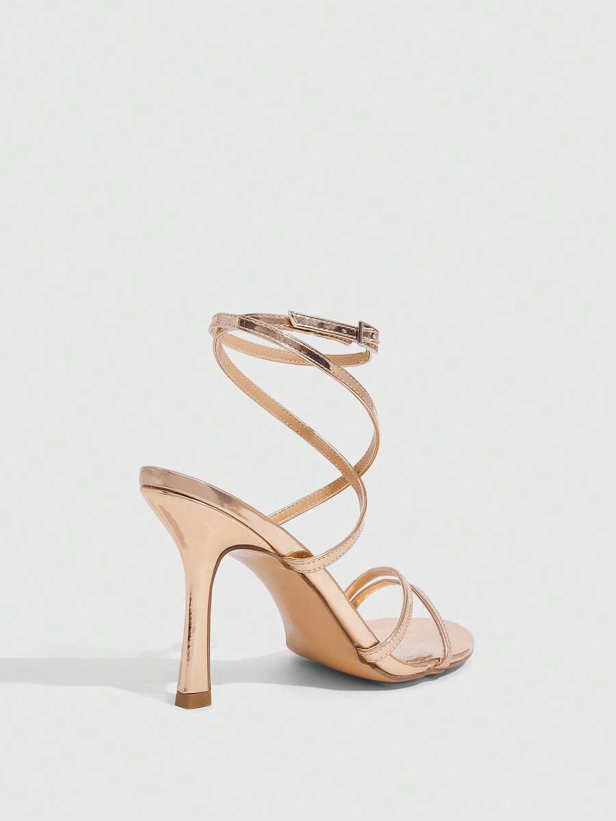 Women's square toe stiletto high heeled sandals with ankle strap buckle in a sleek faux leather finish.