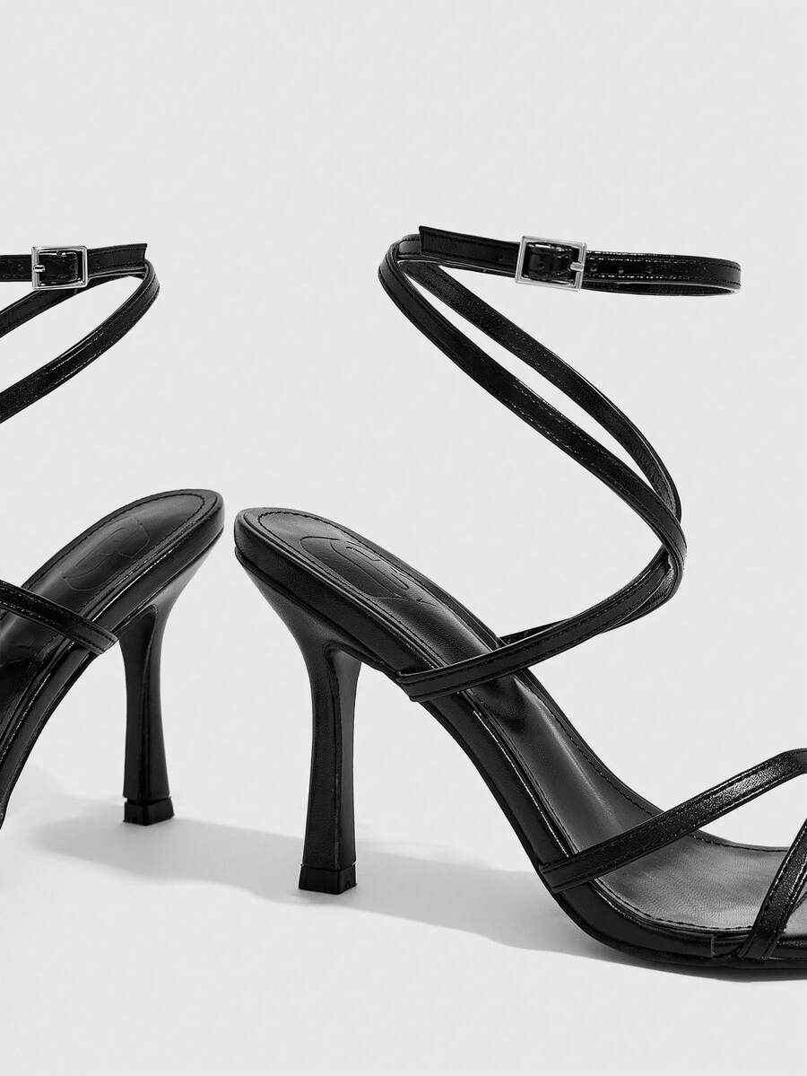 Women's square toe stiletto high heeled sandals with ankle strap buckle in a sleek faux leather finish.