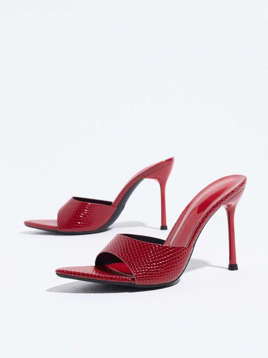 Women's coffee brown high heel mule shoes featuring a glossy mirror finish, open toe design, and sleek stiletto heel.