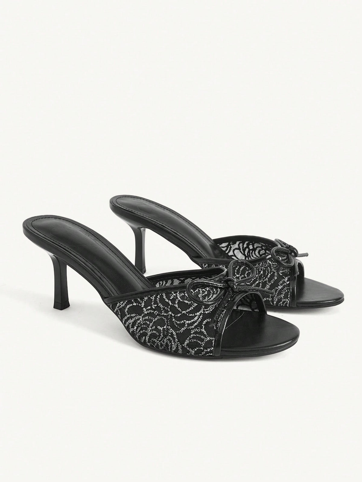 Open toe high heel slide sandals featuring lace details and a bow accent on the upper strap.
