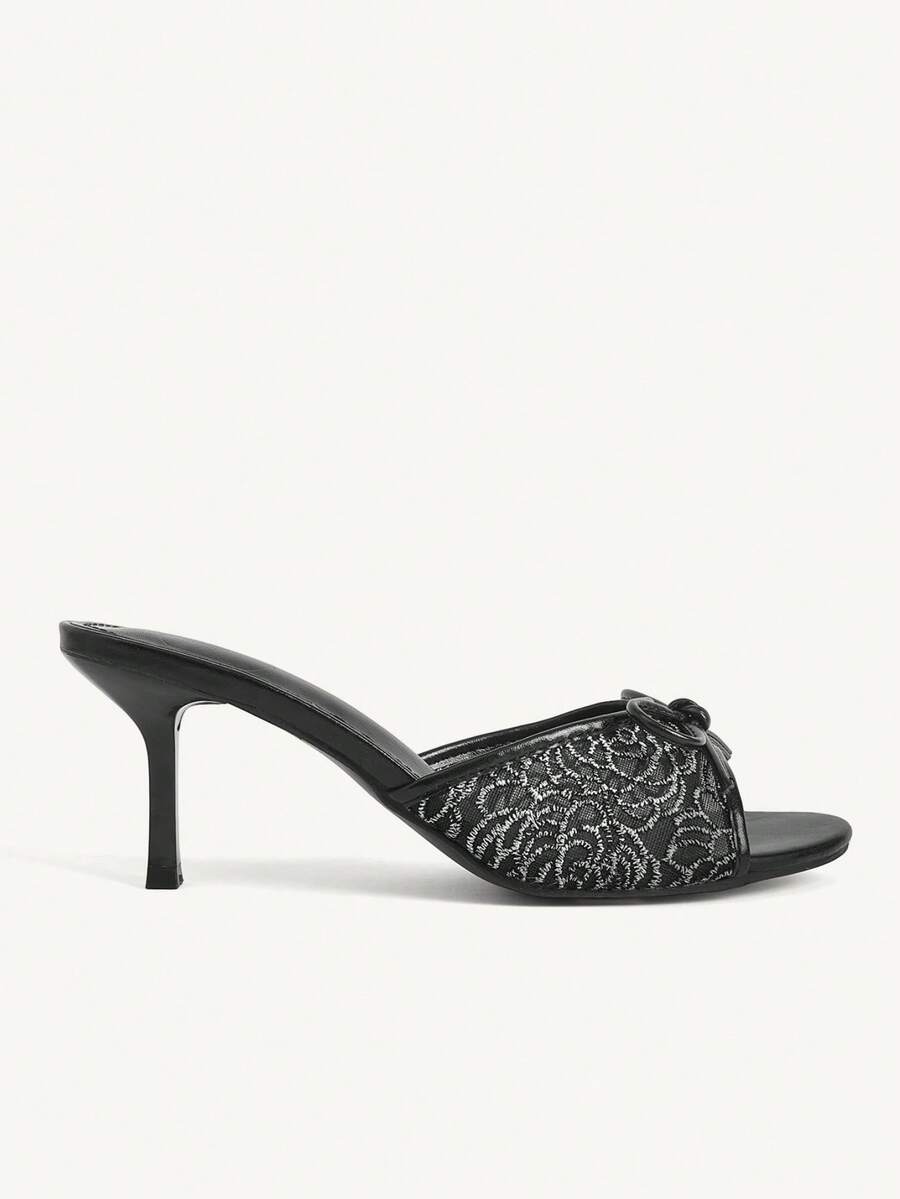 Open toe high heel slide sandals featuring lace details and a bow accent on the upper strap.