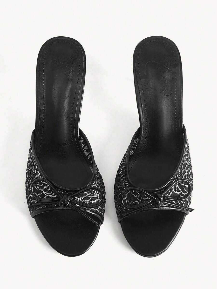 Open toe high heel slide sandals featuring lace details and a bow accent on the upper strap.