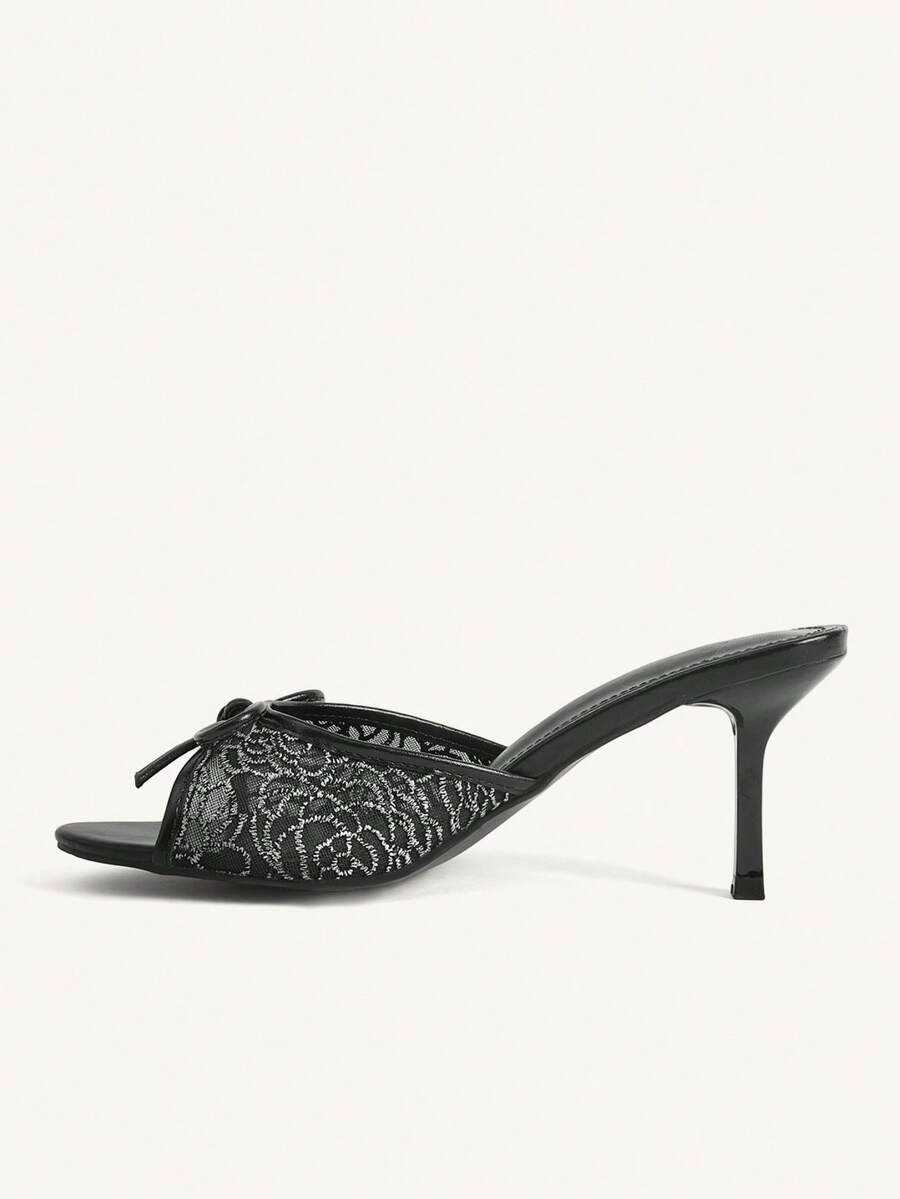 Open toe high heel slide sandals featuring lace details and a bow accent on the upper strap.