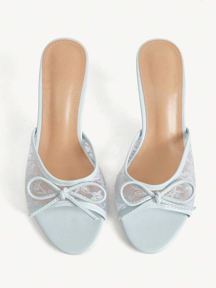 Open toe high heel slide sandals featuring lace details and a bow accent on the upper strap.