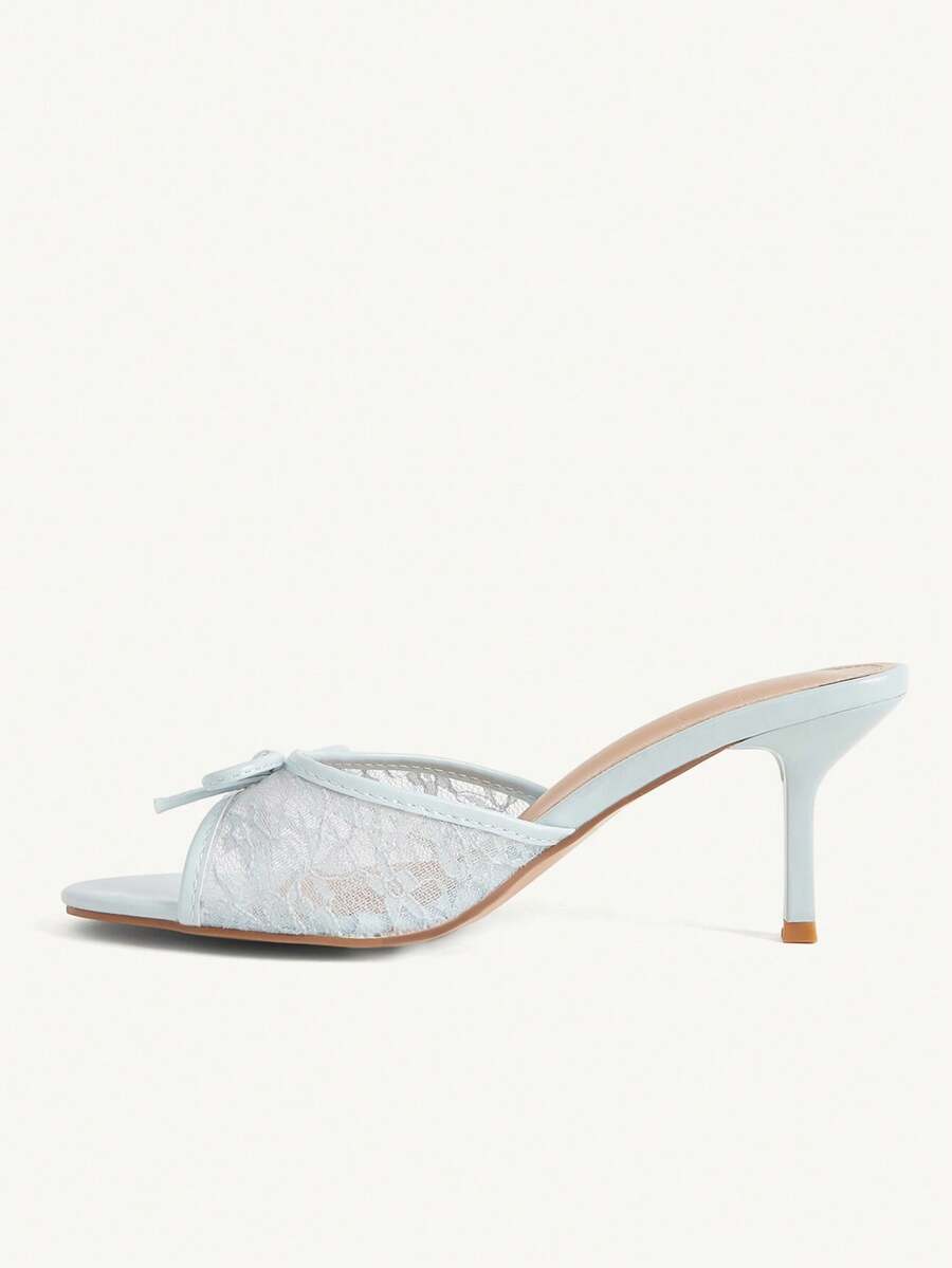 Open toe high heel slide sandals featuring lace details and a bow accent on the upper strap.