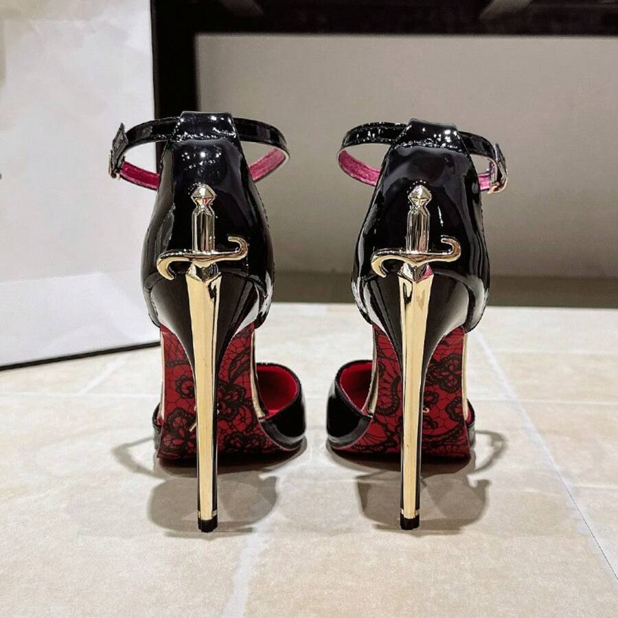 Black pointed toe stiletto pumps featuring an ankle strap with buckle closure and sword back detail.