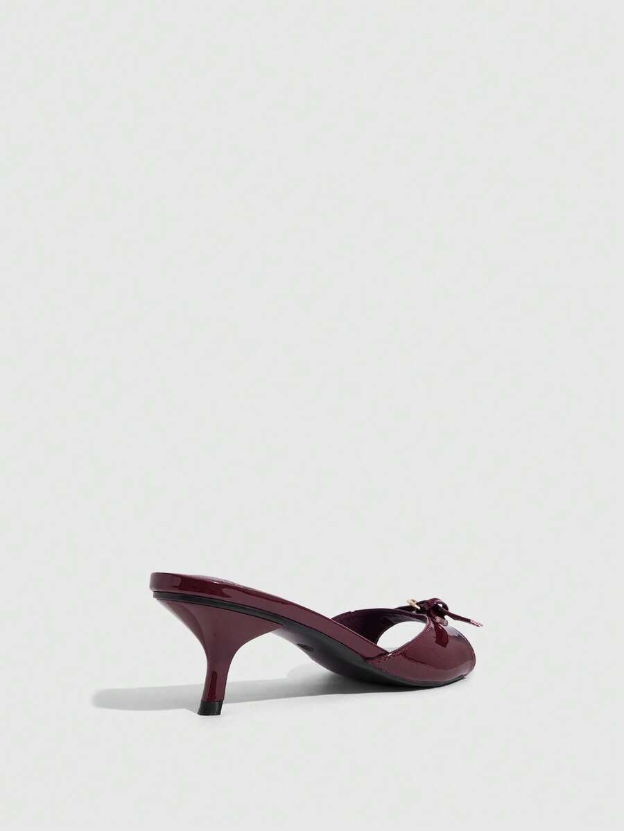 Women's light gold kitten heel slingback sandals featuring an open toe and round buckle strap.