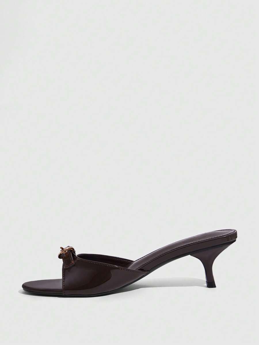 Women's light gold kitten heel slingback sandals featuring an open toe and round buckle strap.