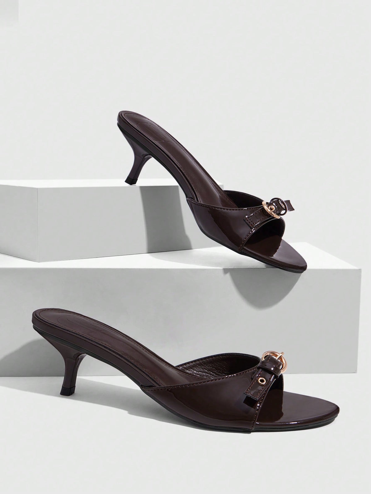 Women's light gold kitten heel slingback sandals featuring an open toe and round buckle strap.