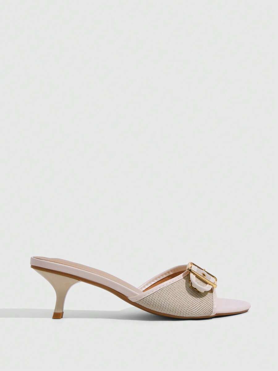 Women's light gold kitten heel slingback sandals featuring an open toe and round buckle strap.