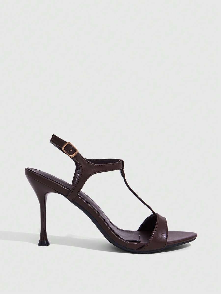 Women's open toe stiletto high heel sandals with T-strap design and adjustable ankle buckle closure in sleek PU leather.