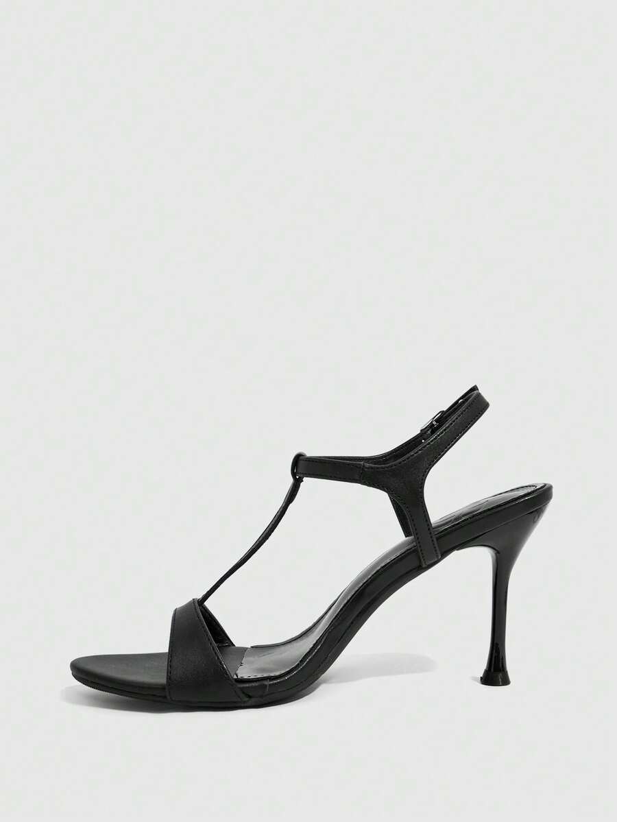 Women's open toe stiletto high heel sandals with T-strap design and adjustable ankle buckle closure in sleek PU leather.
