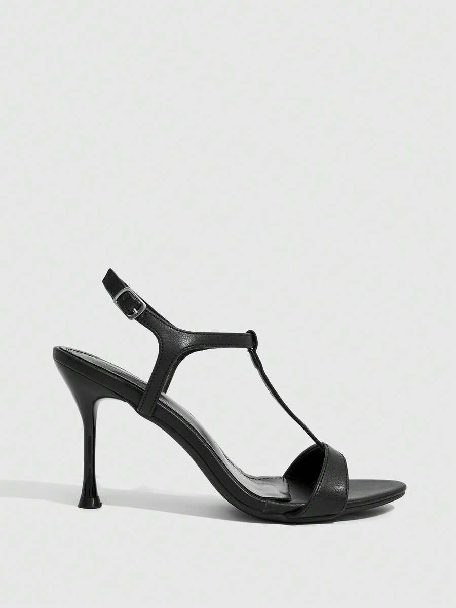 Women's open toe stiletto high heel sandals with T-strap design and adjustable ankle buckle closure in sleek PU leather.