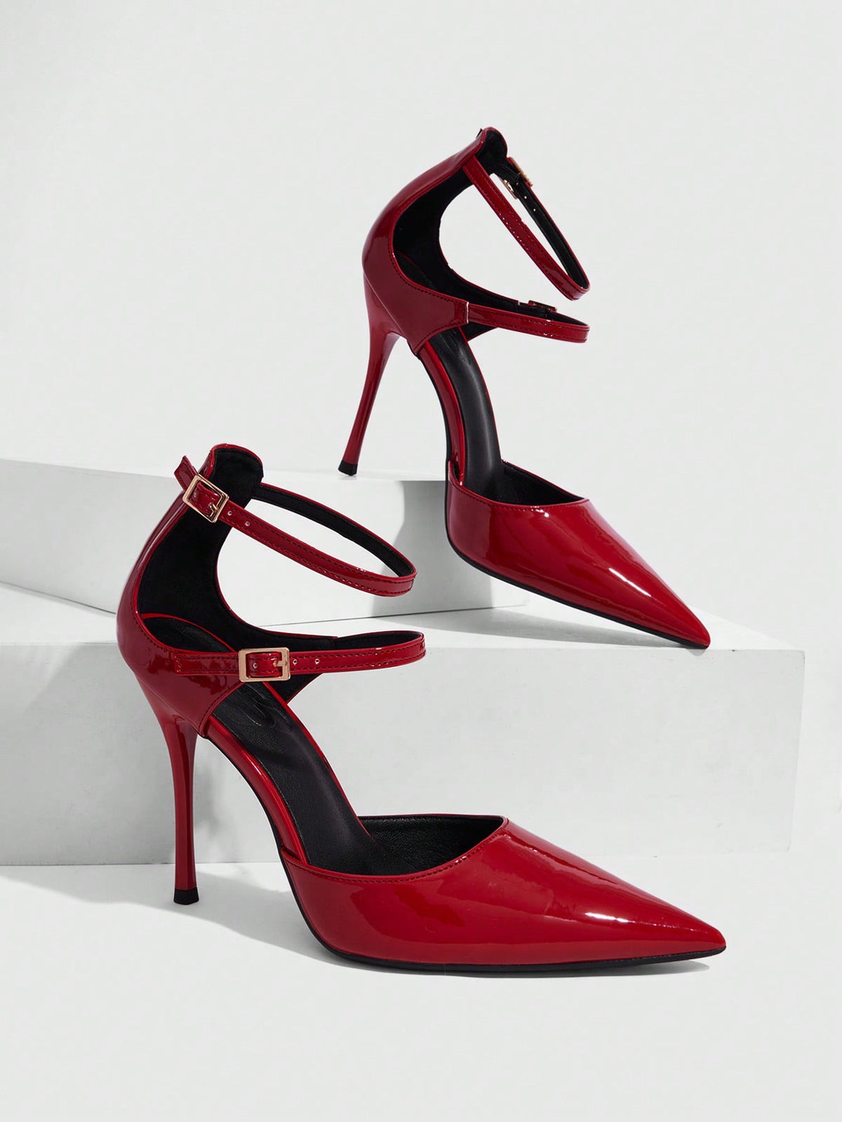 Red pointed toe stiletto high heels with ankle strap made of smooth PU leather for women.
