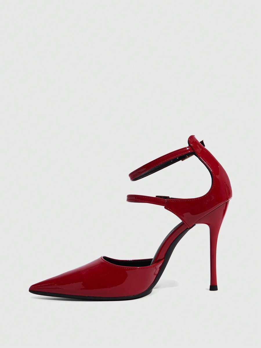 Red pointed toe stiletto high heels with ankle strap made of smooth PU leather for women.