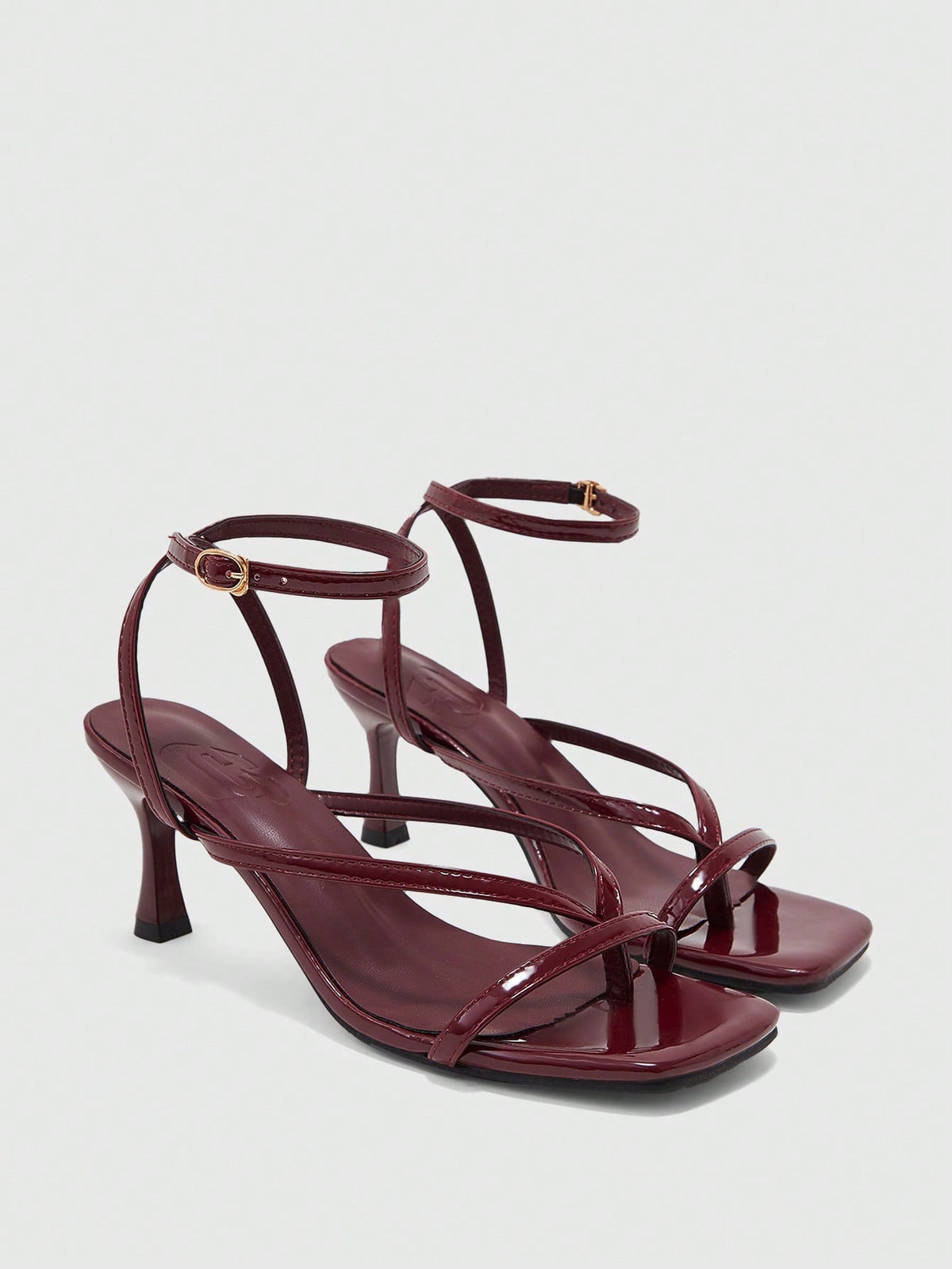 Burgundy women's thin strap thong sandals with ankle strap and kitten heels.