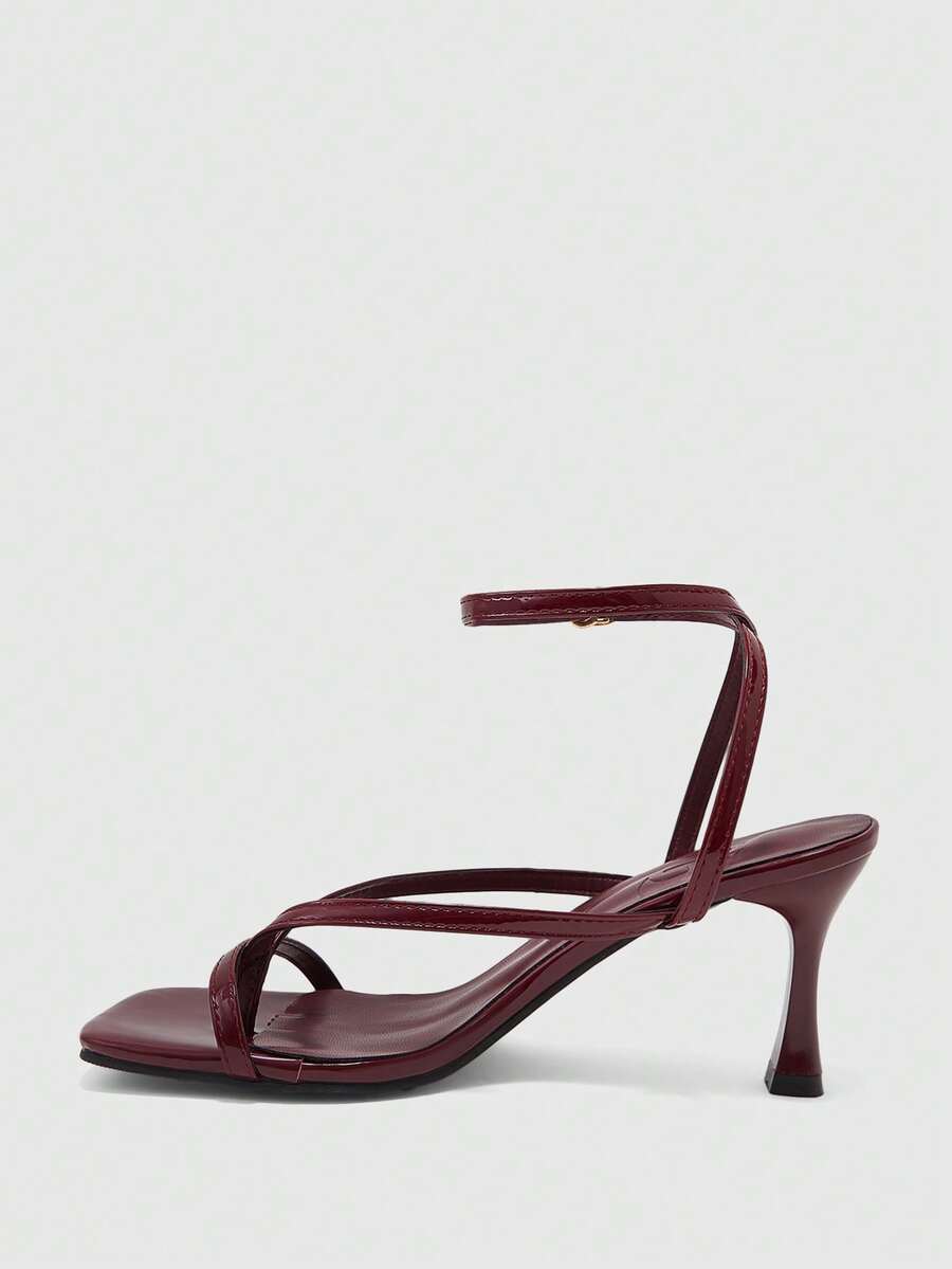 Burgundy women's thin strap thong sandals with ankle strap and kitten heels.