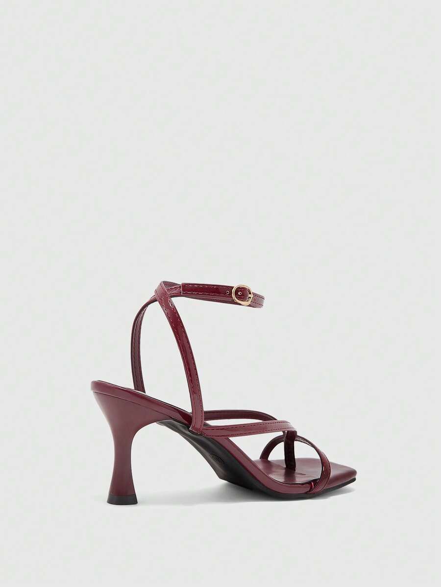 Burgundy women's thin strap thong sandals with ankle strap and kitten heels.