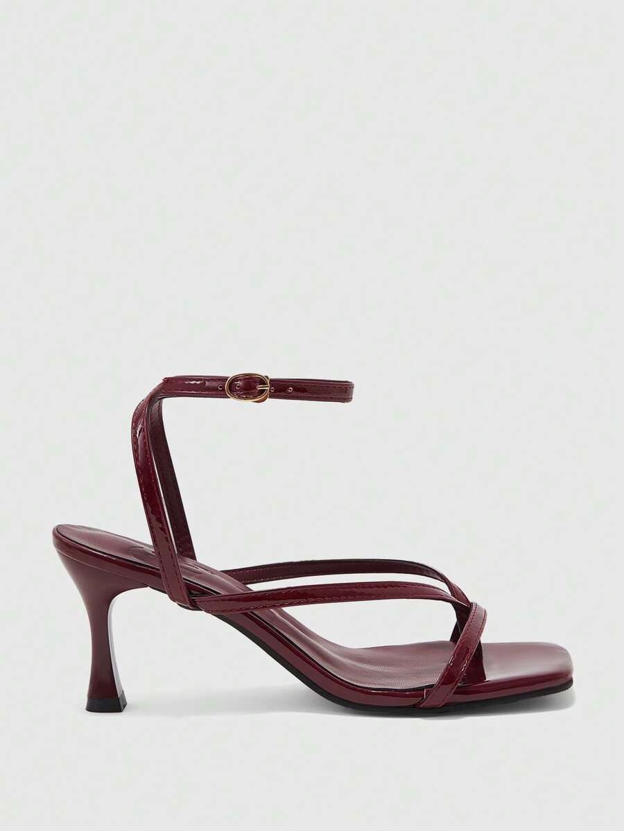 Burgundy women's thin strap thong sandals with ankle strap and kitten heels.