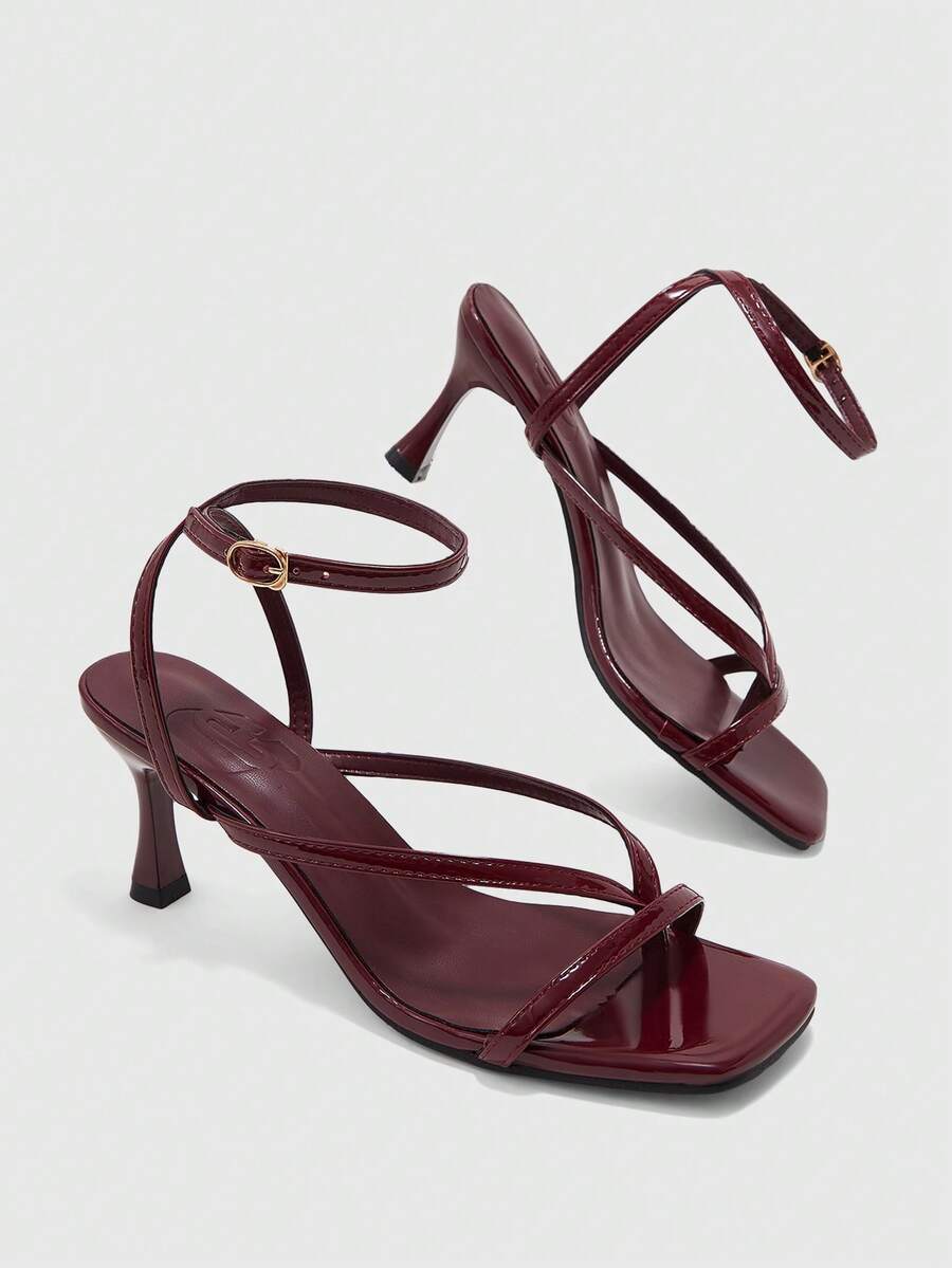 Burgundy women's thin strap thong sandals with ankle strap and kitten heels.