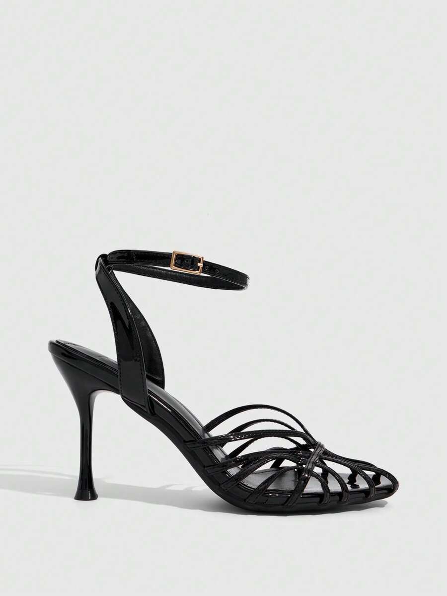 Women's glossy silver open-toed sandals with thin pyramid heel and strappy ribbon details.