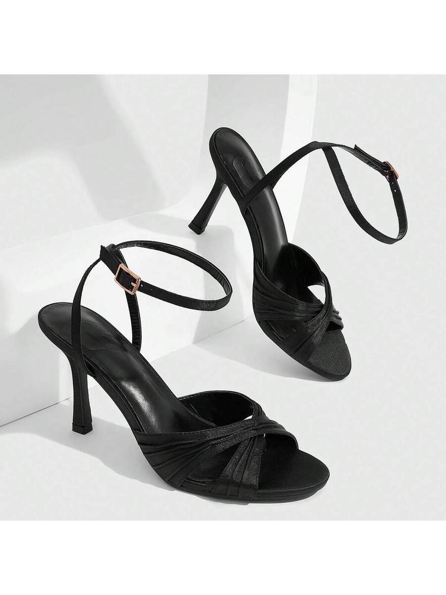 Women's high heel sandals featuring pleated strap detailing, an adjustable ankle strap with buckle closure, round open toe, and slim stiletto heel.