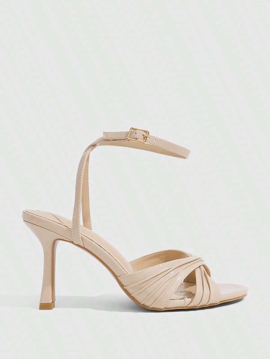 Women's high heel sandals featuring pleated strap detailing, an adjustable ankle strap with buckle closure, round open toe, and slim stiletto heel.