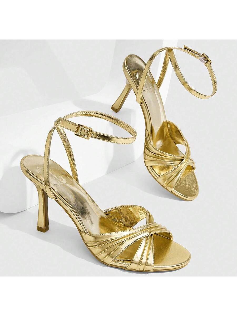 Women's high heel sandals featuring pleated strap detailing, an adjustable ankle strap with buckle closure, round open toe, and slim stiletto heel.