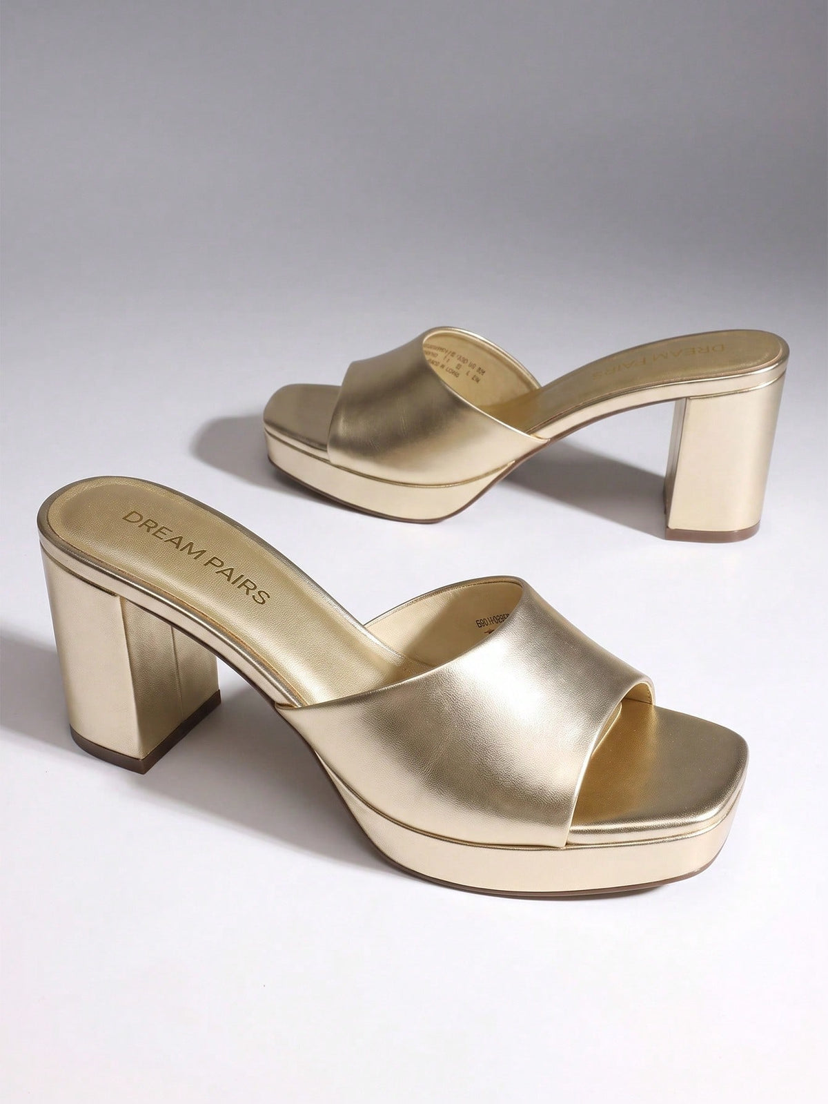 Women's minimalist open toe mule sandals featuring a chunky low heel, wide single strap, and slip-on design.