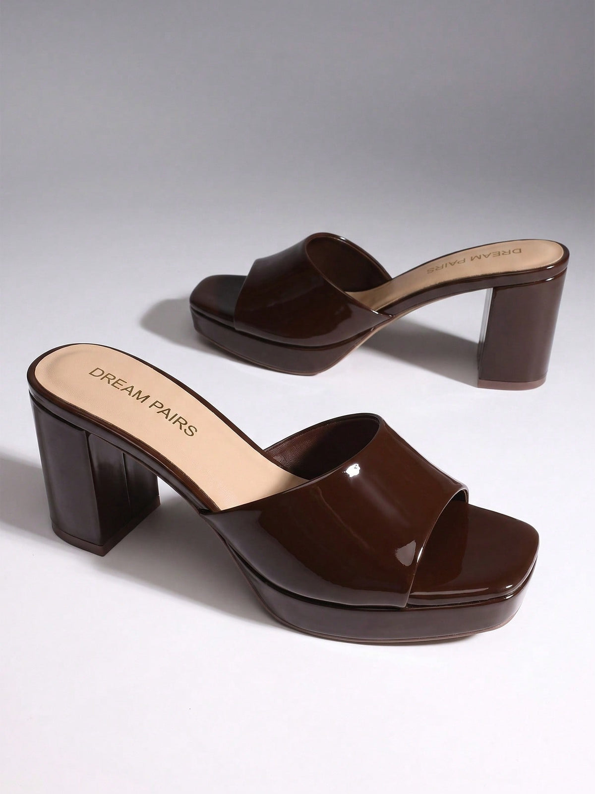 Women's minimalist open toe mule sandals featuring a chunky low heel, wide single strap, and slip-on design.
