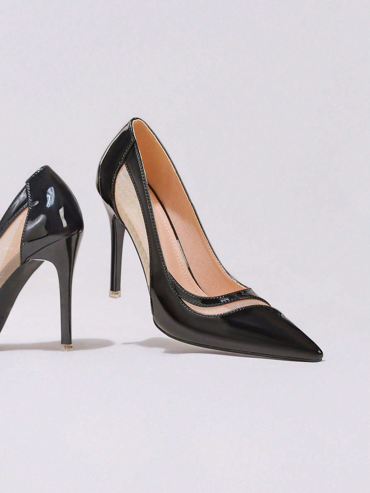 Black lace pointed toe high heel pumps featuring stiletto heels and a decorative bow accent.