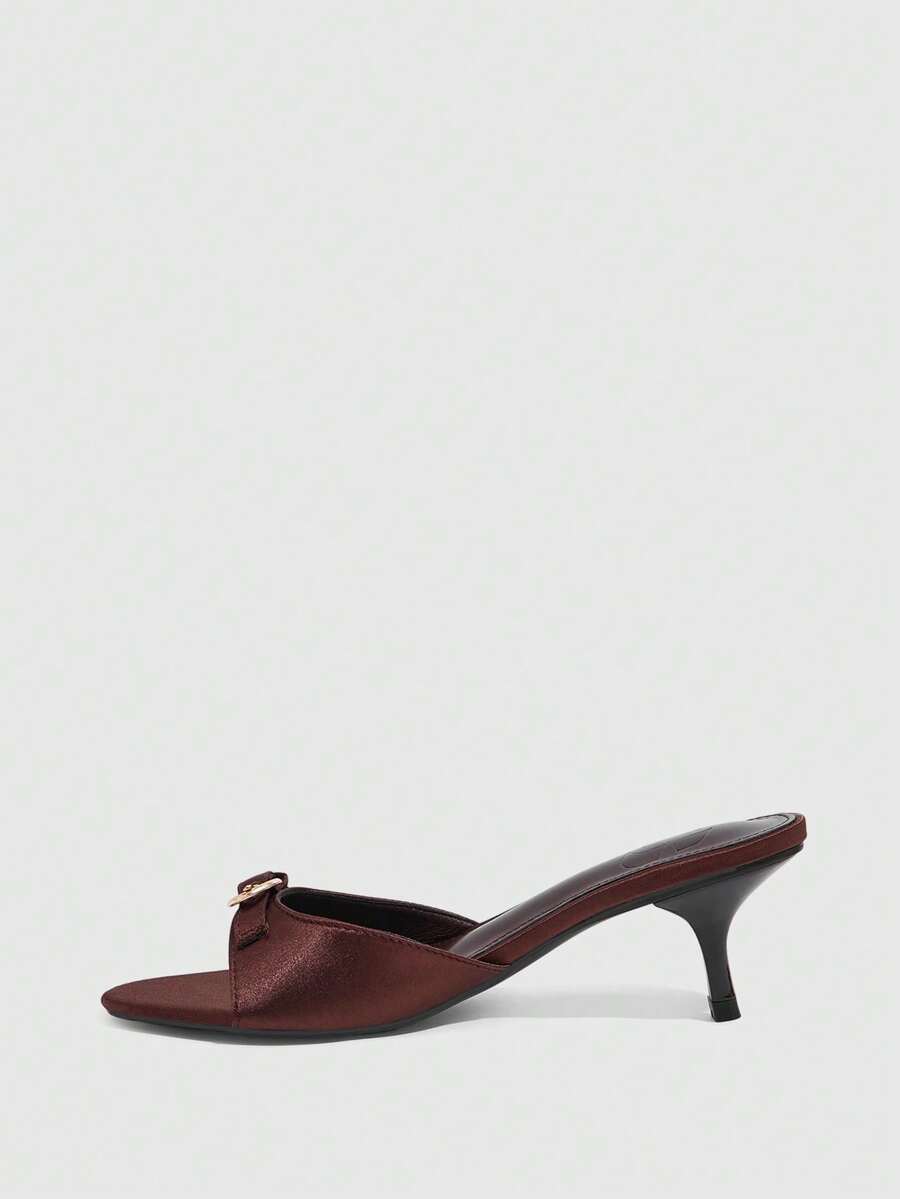 Women's light gold kitten heel slingback sandals featuring an open toe and round buckle strap.