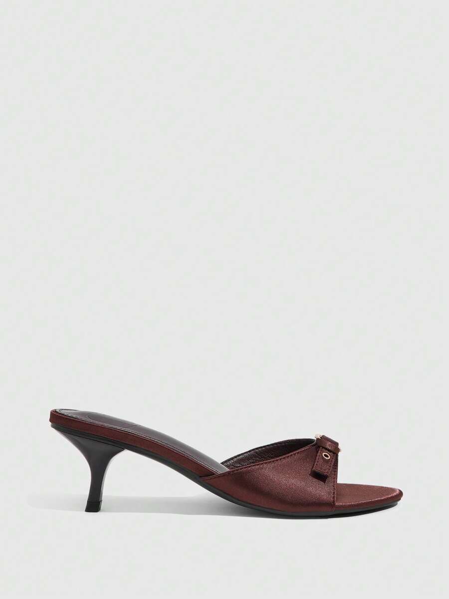 Women's light gold kitten heel slingback sandals featuring an open toe and round buckle strap.