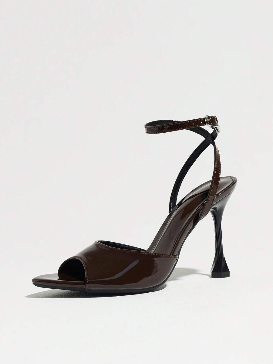 Women's black open toe stiletto heel sandals featuring lace mesh detailing, wide strap styling, and high stiletto heels.