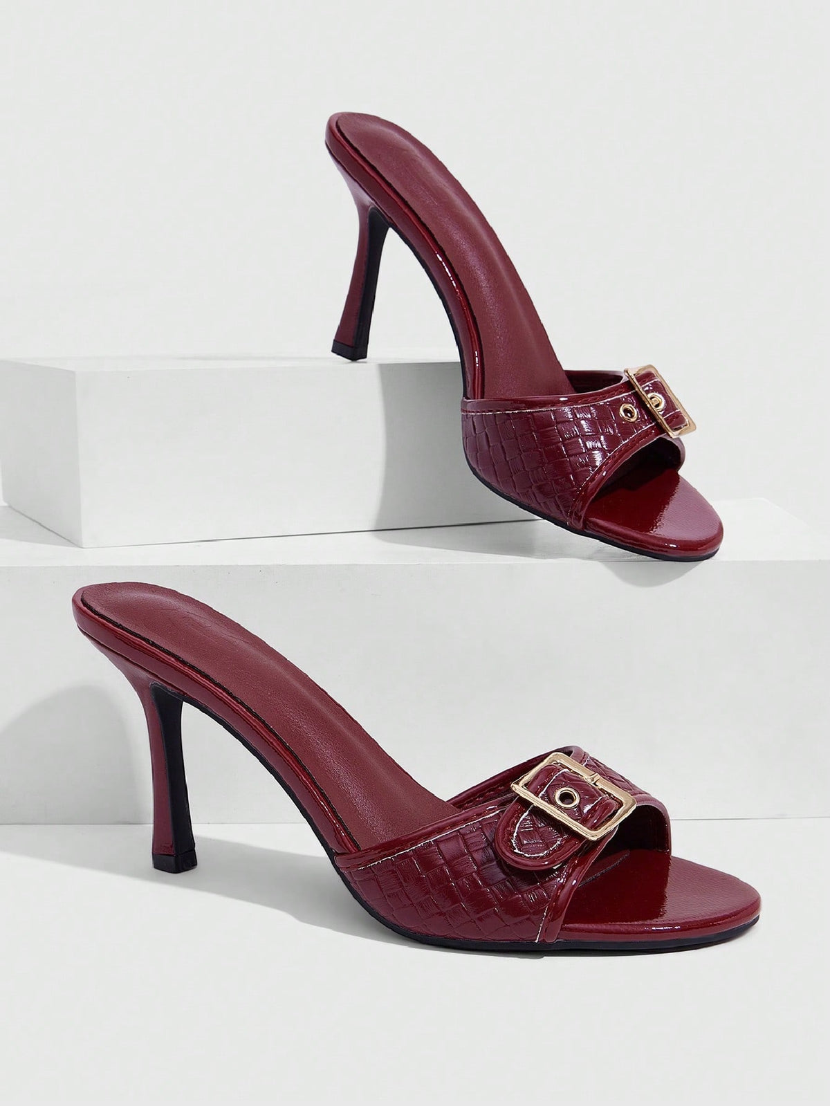 Women's brown leopard print high heel mule sandals with gold-tone buckle and grommet eyelet accents.