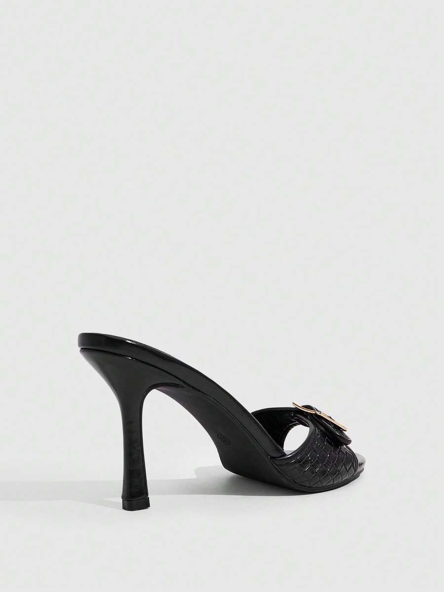 Women's brown leopard print high heel mule sandals with gold-tone buckle and grommet eyelet accents.