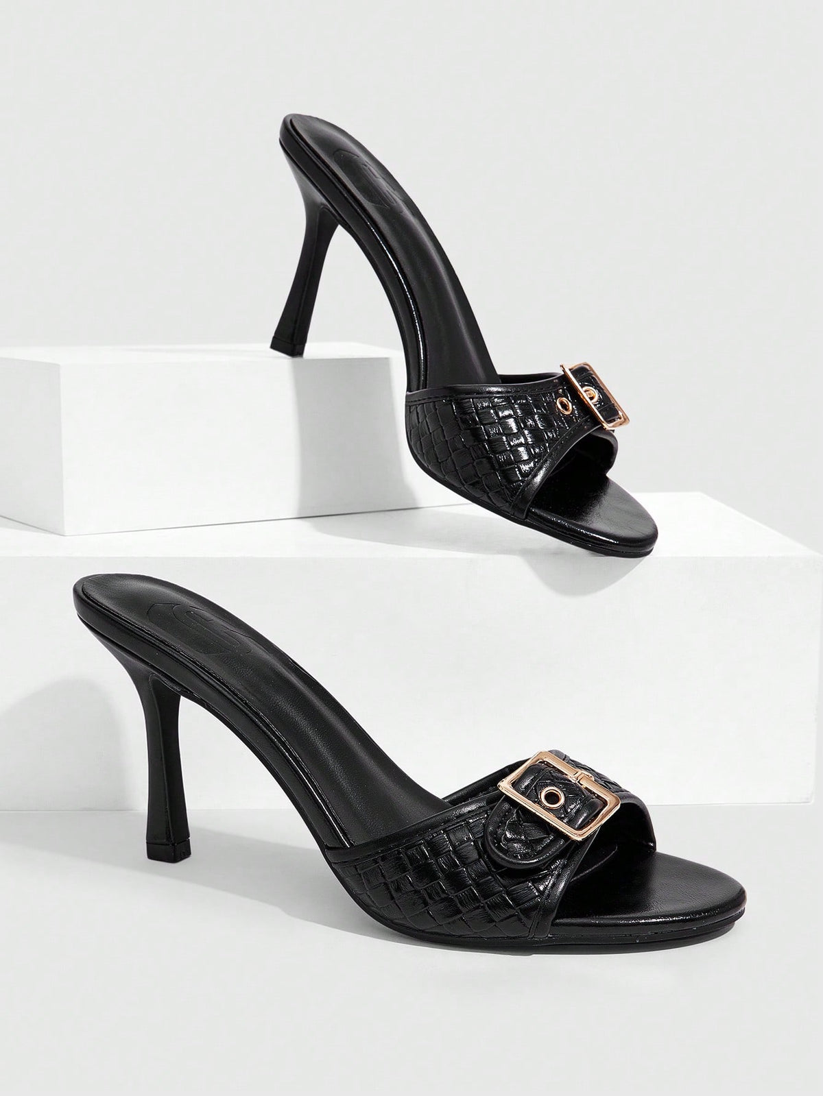 Women's brown leopard print high heel mule sandals with gold-tone buckle and grommet eyelet accents.