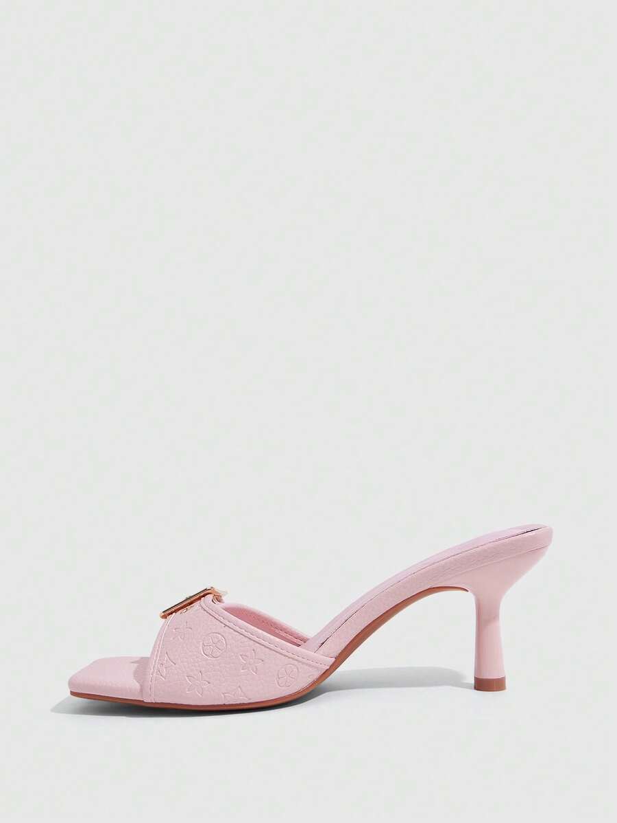 Beige women's slip-on kitten heel slide sandals featuring an accent buckle with grommet eyelets.