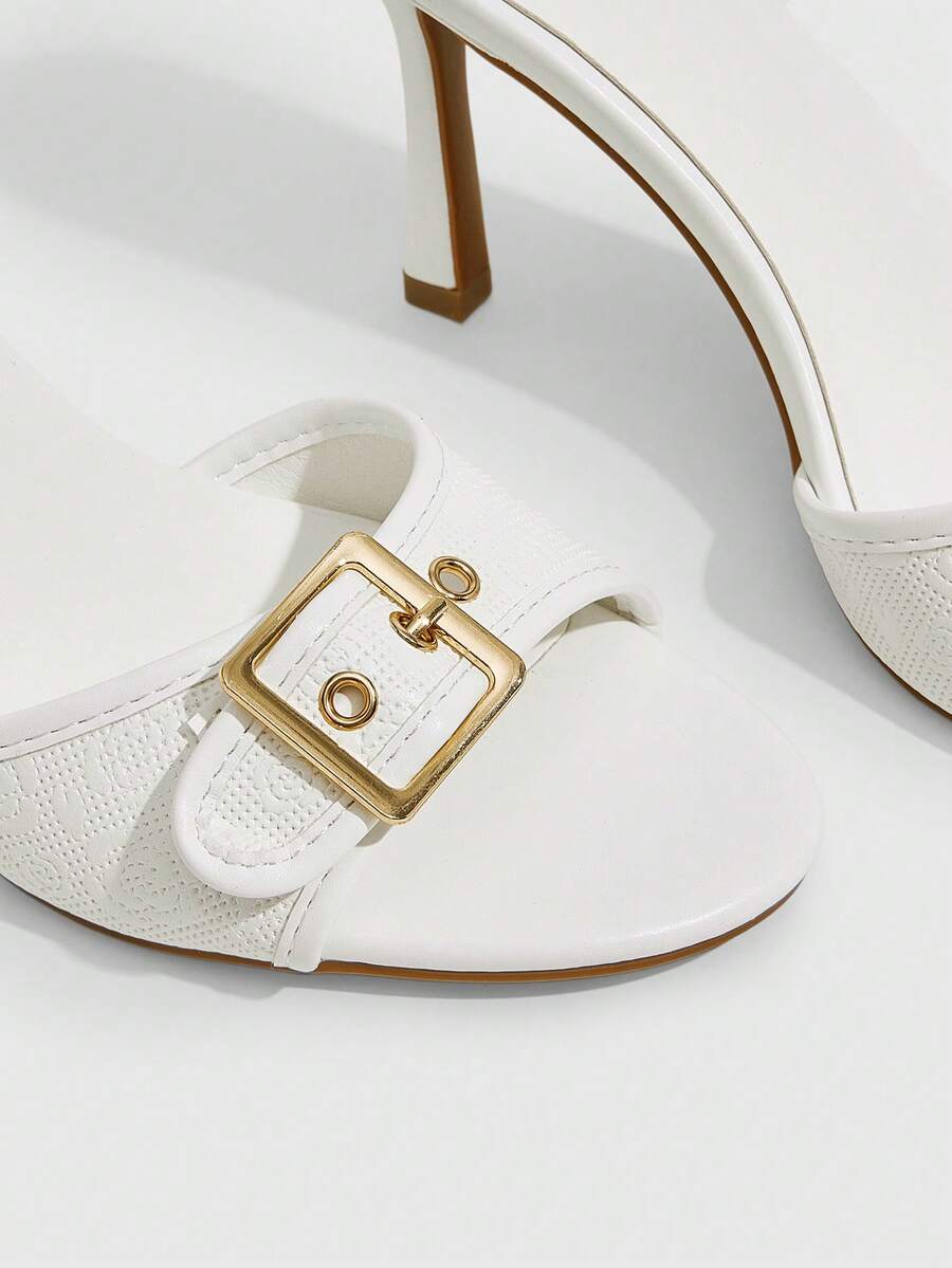 Women's brown leopard print high heel mule sandals with gold-tone buckle and grommet eyelet accents.
