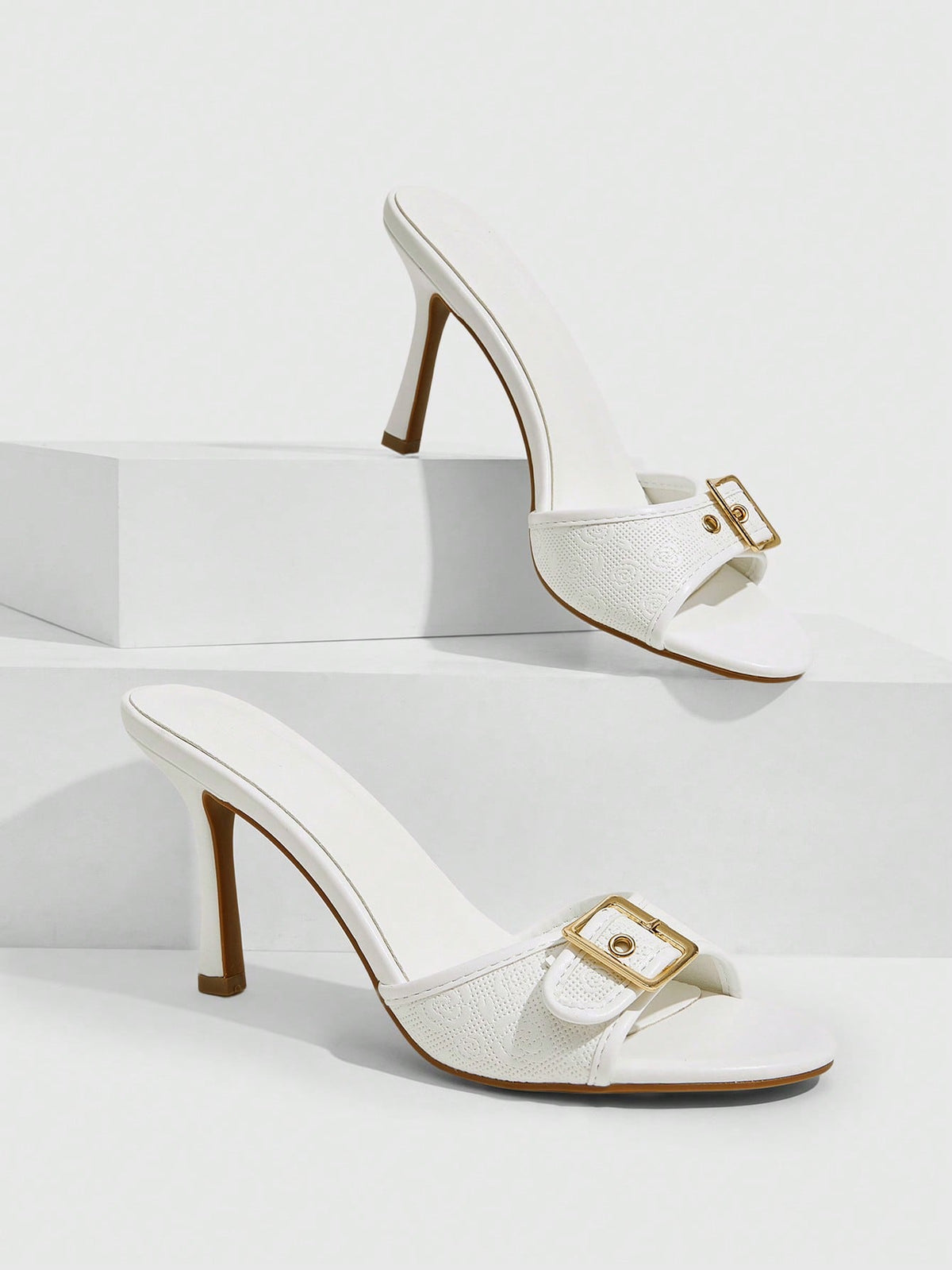 Women's brown leopard print high heel mule sandals with gold-tone buckle and grommet eyelet accents.
