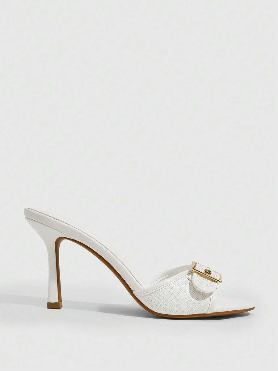 Women's brown leopard print high heel mule sandals with gold-tone buckle and grommet eyelet accents.
