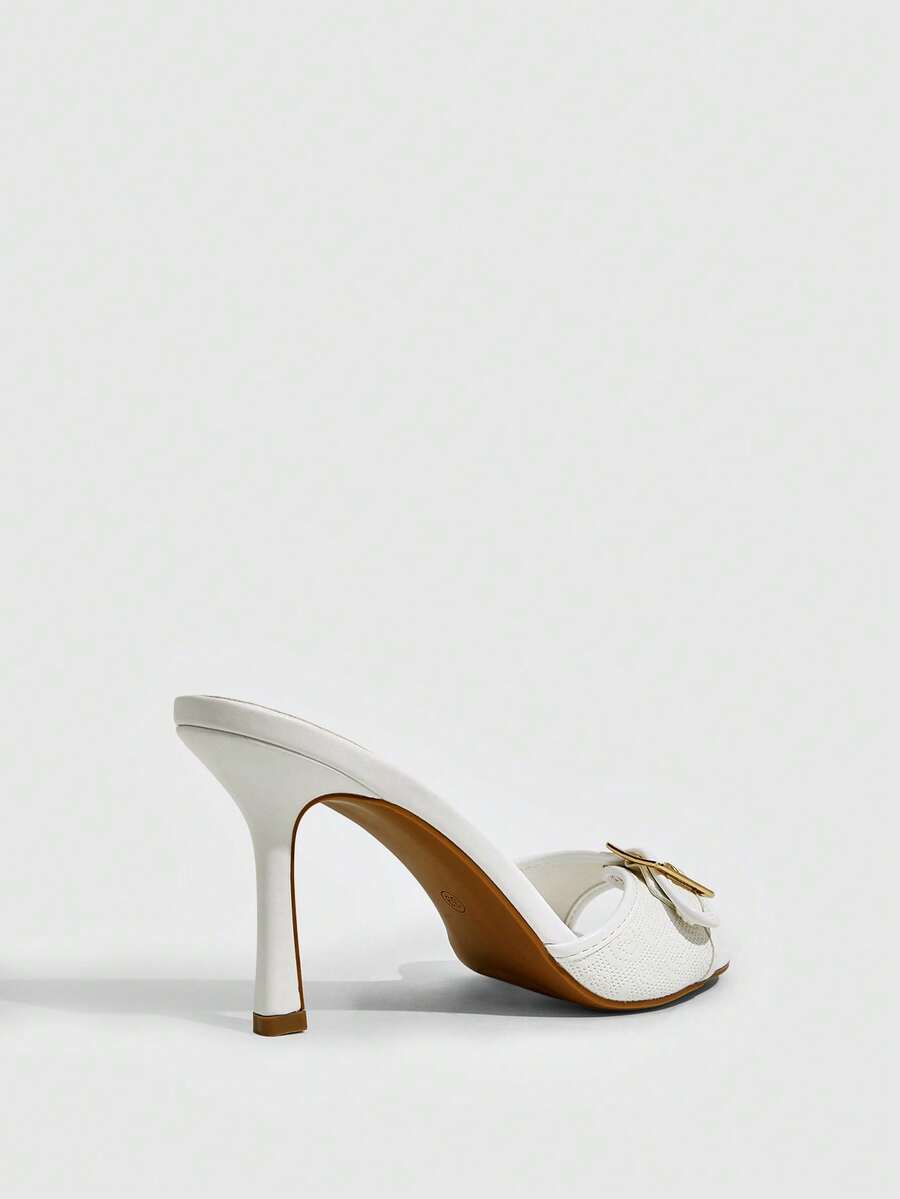 Women's brown leopard print high heel mule sandals with gold-tone buckle and grommet eyelet accents.